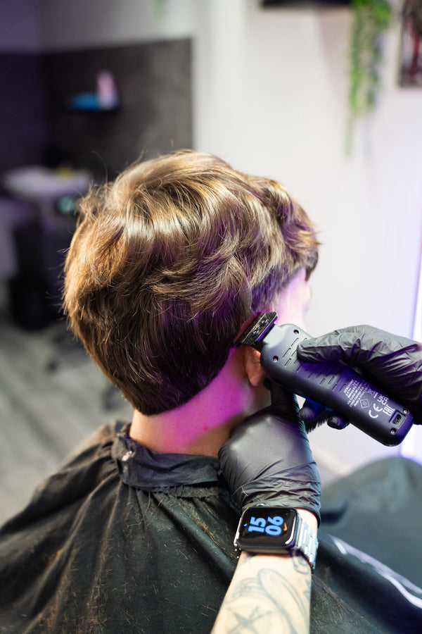 TJ Wolf Cutss clipper work on client