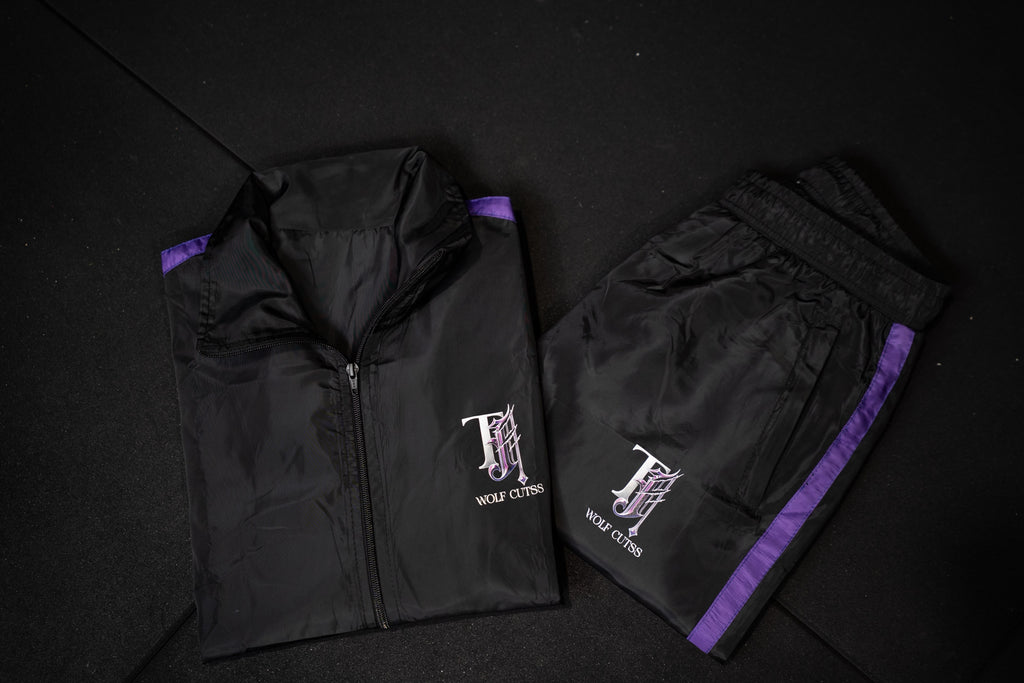 Full TJ Wolf Cutss black tracksuit set flat lay, jacket and pants together